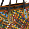 A large, colorful women's handbag, perfect for travel